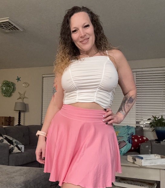 Photo of Rayna in a white top and pink skirt